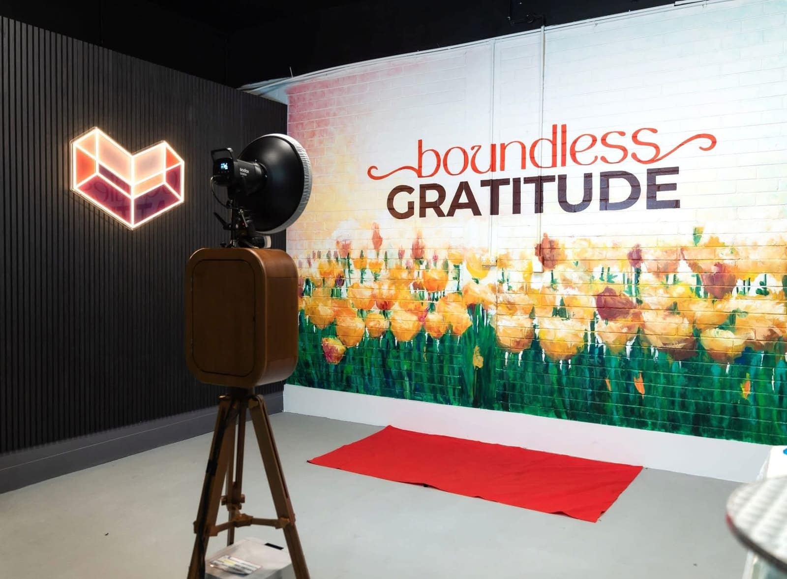 A guest posing inside a curtained photo booth